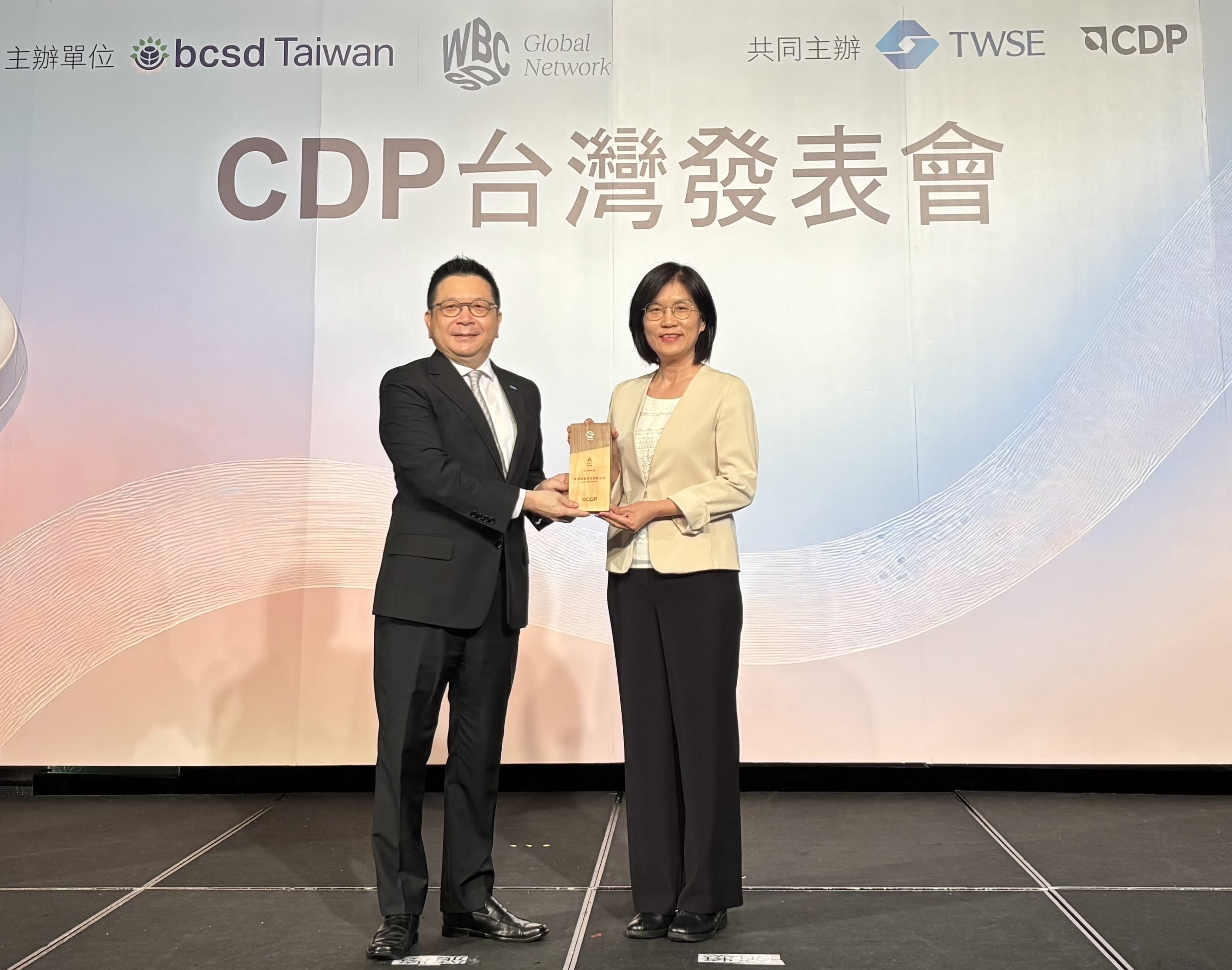 友達永續成果再獲國際評比肯定，獲頒CDP氣候與水資源雙項領導力評級。今由臺灣證券交易所董事長林修銘（左）頒獎，友達光電永續長古秀華（右）代表受獎